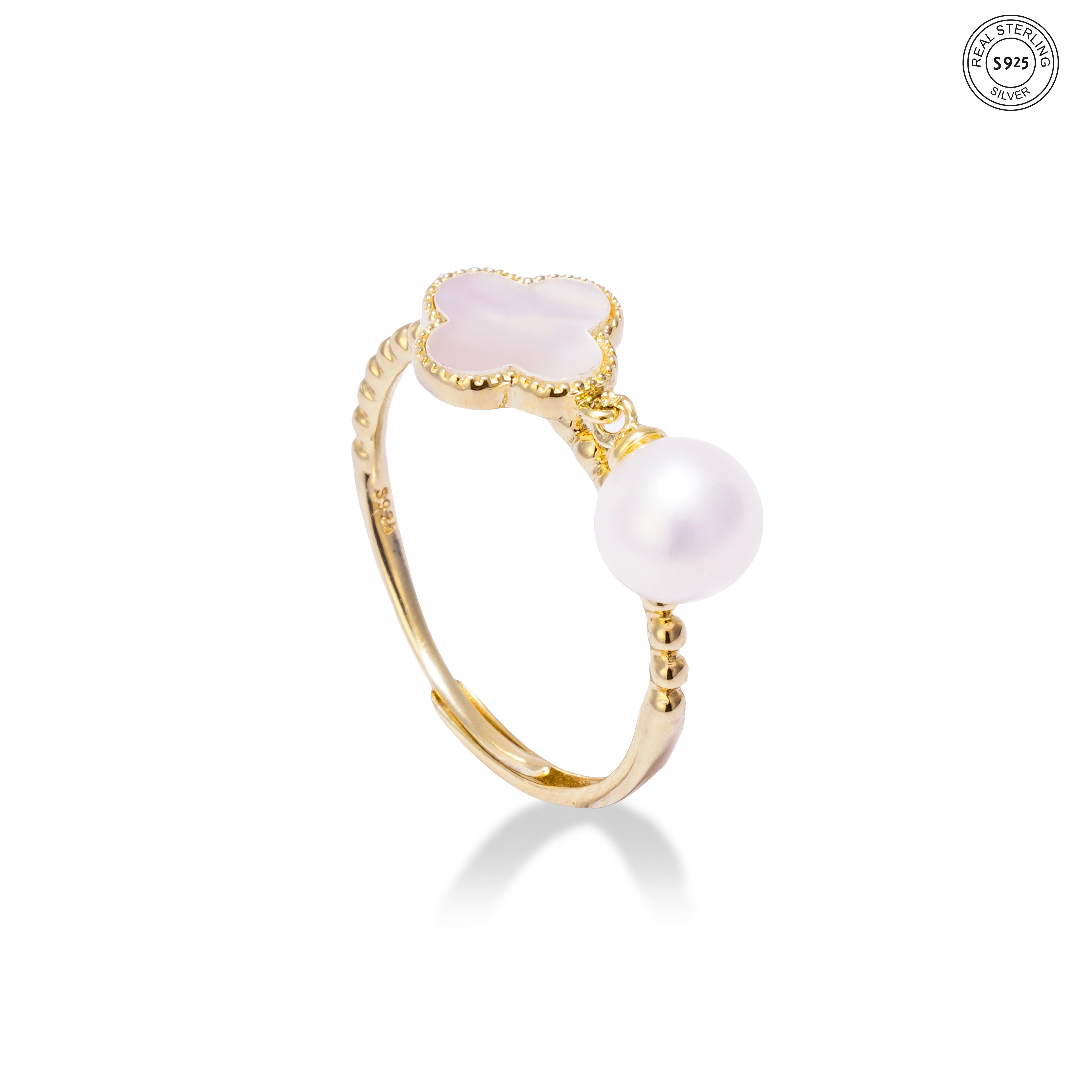 Gold plated silver ring with pink stones and a pearl on a white background
