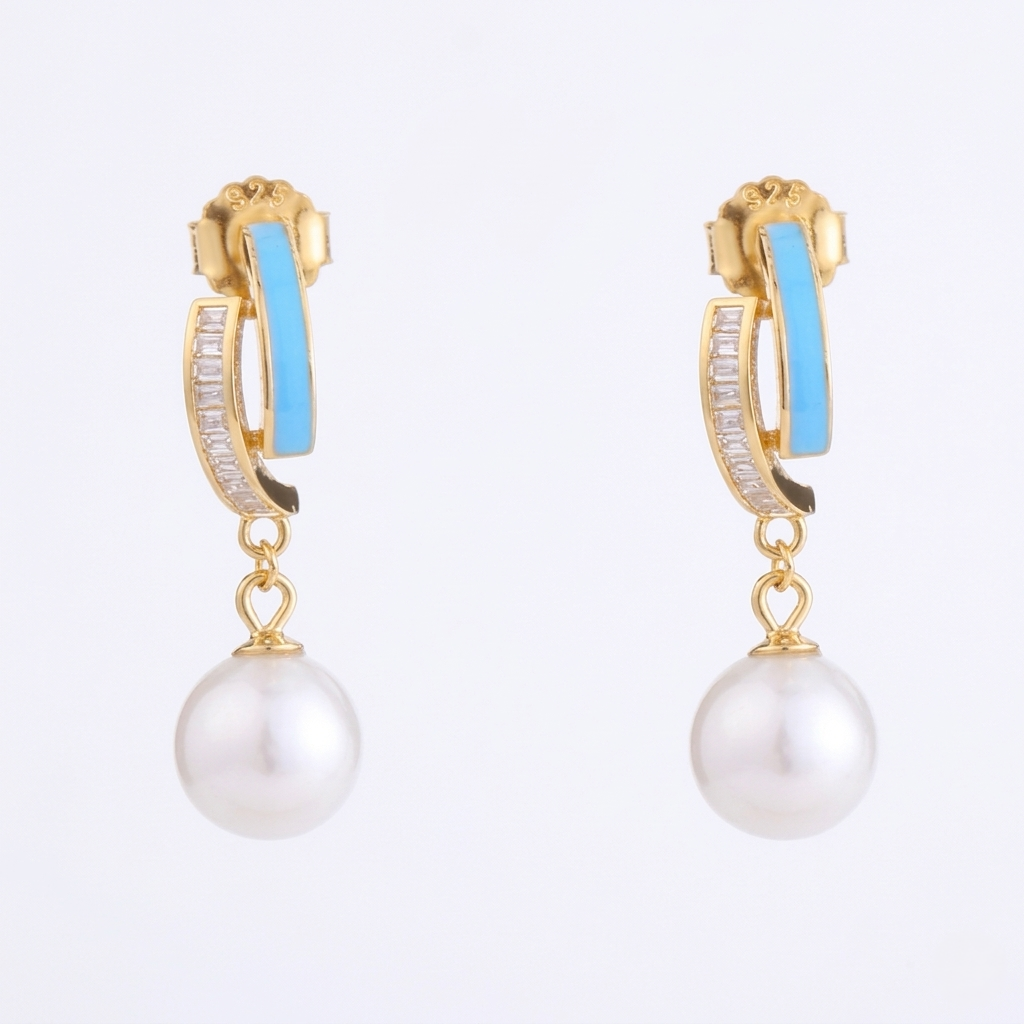 Gold hoop earrings with pearl drops on a white background