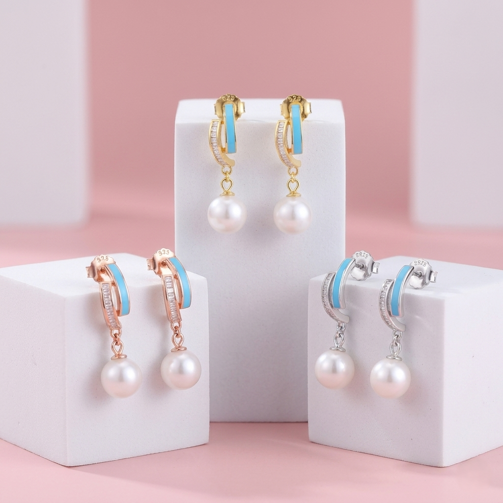 Pearl earrings with blue accents on white stands against a pink background